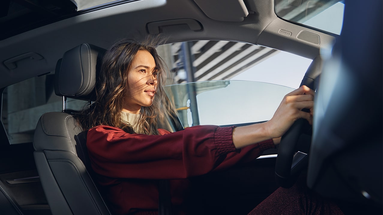 Interior cabin view showing a person driving an Audi.