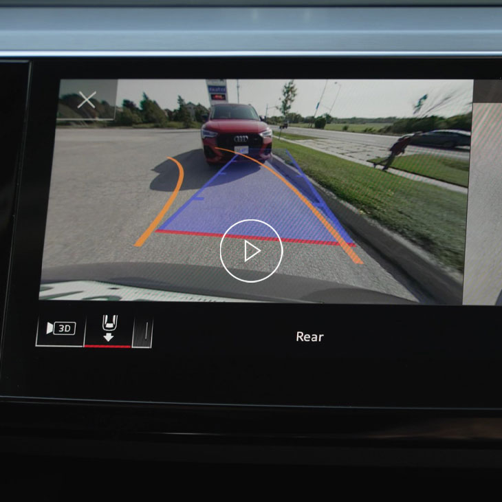 Close-up of the Audi MMI system displaying parking aid technology. 