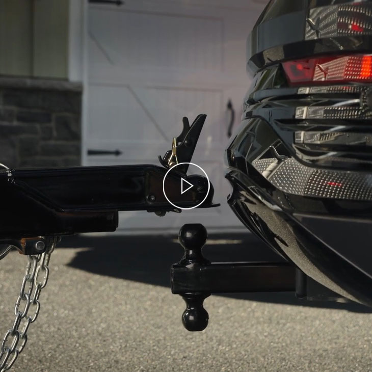 Close-up on an Audi vehicle connecting to a trailer. 