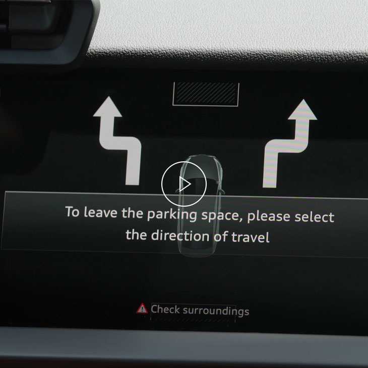 Close-up of the Audi MMI system displaying park assist technology.