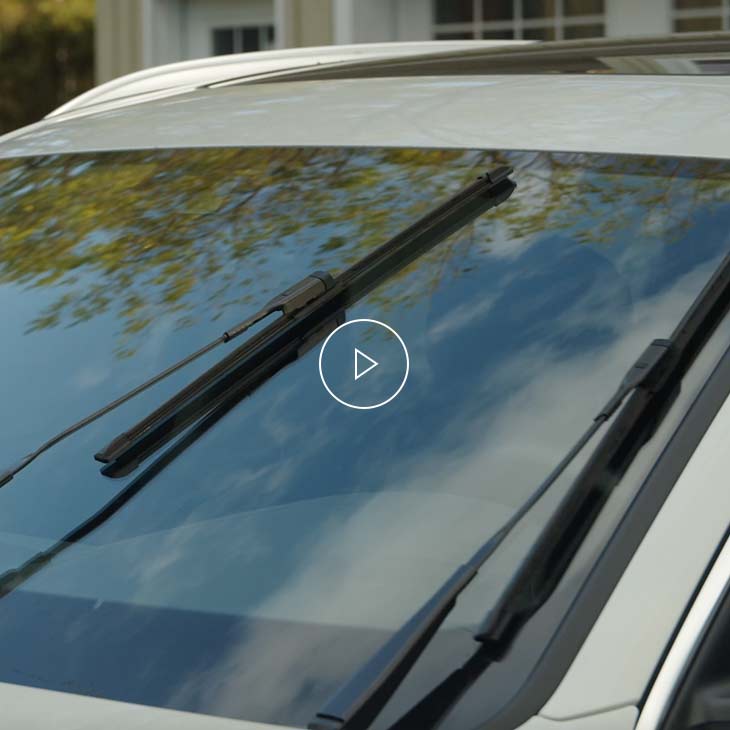  Close-up photo of the windshield wipers of an Audi vehicle. 