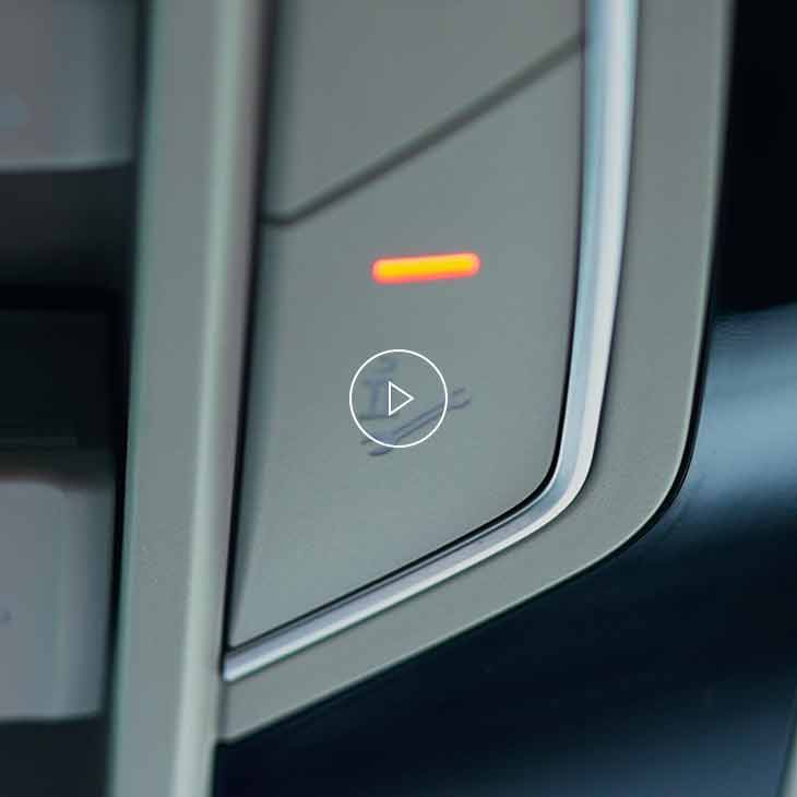  Close-up photo of the Roadside Assistance button inside an Audi vehicle. 