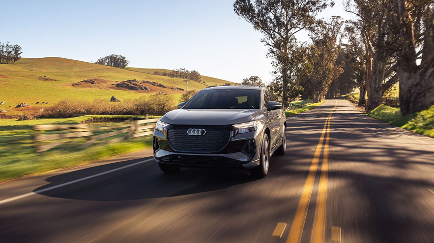 3/4 front view of an Audi Q4 e-tron in motion. 