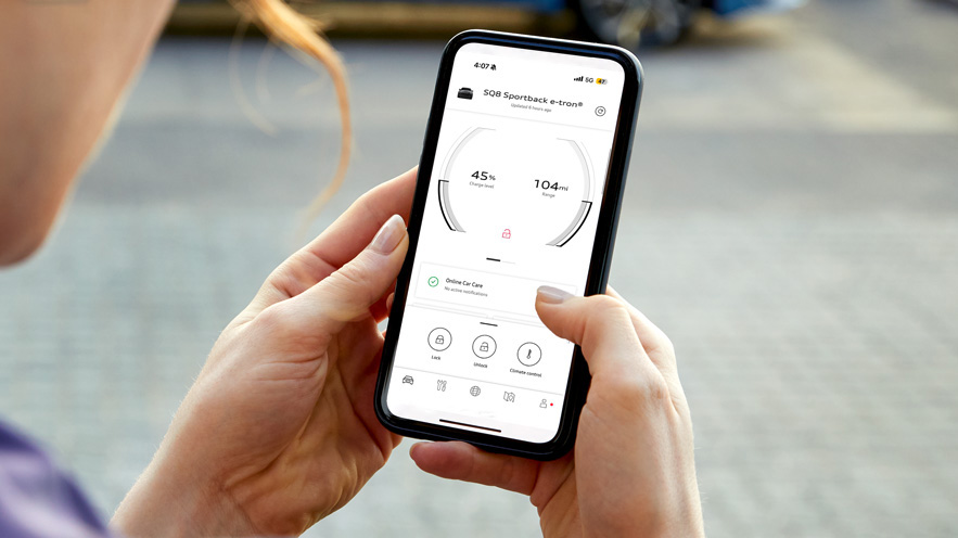 Person on their phone looking at the myAudi app.