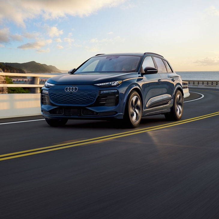 Three-quarter front view of the Audi Q6 e-tron in motion.